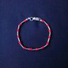 Pulsera tubos de plata y mullos rojos